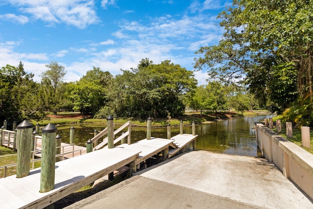 4060 Lake Dr, Coconut Creek, FL 33066 - dock featuring a boat ramp, a water view, and view of wooded area