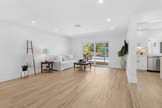 4060 Lake Dr, Coconut Creek, FL 33066 - living room featuring light wood finished floors, recessed lighting, and baseboards