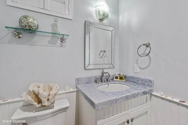 3421 S Ocean Blvd Unit 1, Highland Beach, FL 33487 - bathroom with a wainscoted wall, vanity, and toilet