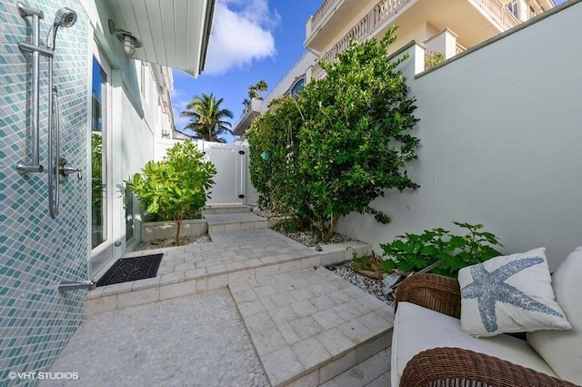 3421 S Ocean Blvd Unit 1, Highland Beach, FL 33487 - view of home's exterior with a gate, a patio area, and fence