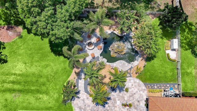 aerial view of property and surrounding area with a small pond