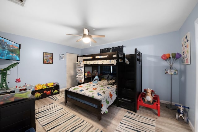 bedroom featuring wood finished floors, baseboards, and ceiling fan