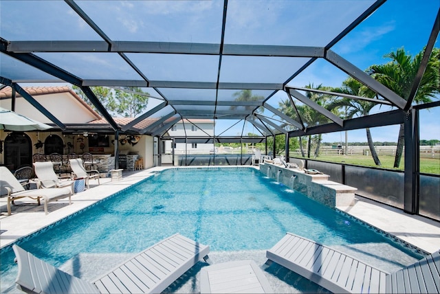 swimming pool featuring a patio and glass enclosure