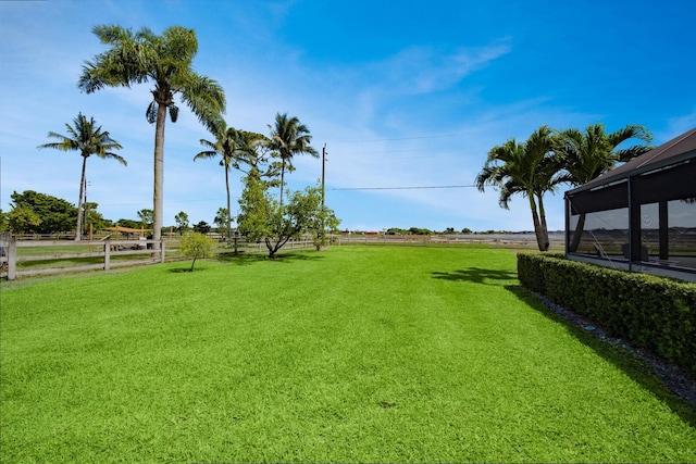 view of grassy yard featuring a rural view