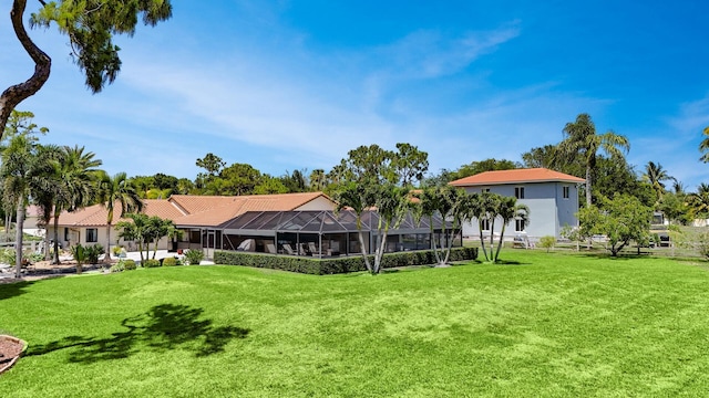 view of grassy yard featuring a lanai
