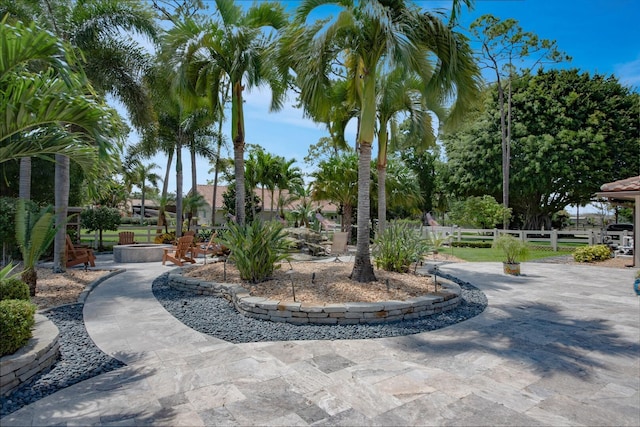 view of community with fence and a patio area