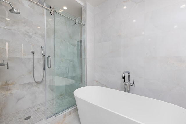 475 E Royal Palm Rd Unit 205, Boca Raton, FL 33432 - bathroom with a shower stall, a freestanding bath, and tile walls