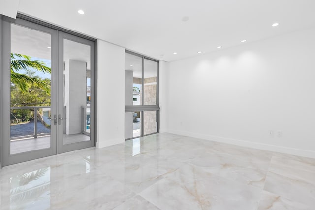 475 E Royal Palm Rd Unit 205, Boca Raton, FL 33432 - unfurnished room featuring french doors, recessed lighting, baseboards, floor to ceiling windows, and marble tiled flooring