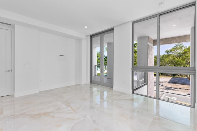 475 E Royal Palm Rd Unit 205, Boca Raton, FL 33432 - spare room with a wall of windows, french doors, a smoke detector, and marble tiled floors