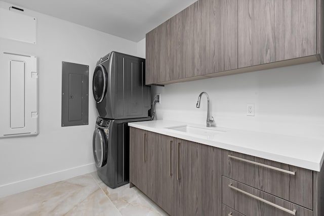 475 E Royal Palm Rd Unit 205, Boca Raton, FL 33432 - washroom featuring stacked washer and clothes dryer, electric panel, cabinet space, and baseboards