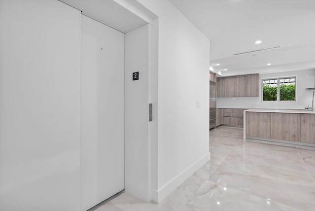 475 E Royal Palm Rd Unit 205, Boca Raton, FL 33432 - hall featuring light marble finish flooring, recessed lighting, baseboards, and elevator
