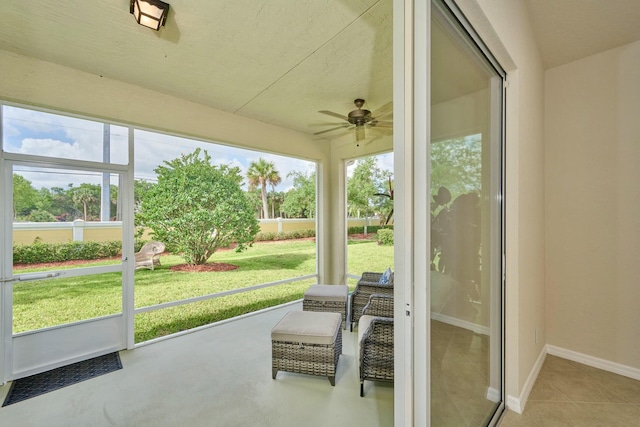 sunroom / solarium with a ceiling fan