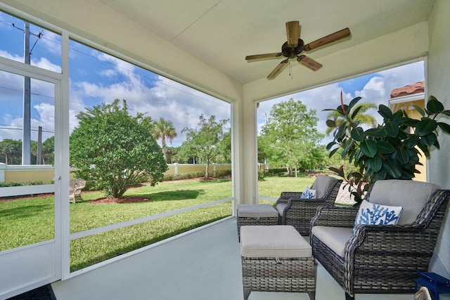 sunroom featuring a ceiling fan