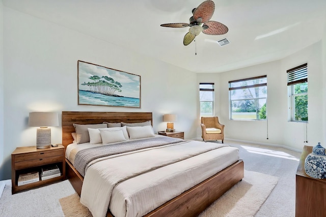 bedroom with light carpet, baseboards, and ceiling fan