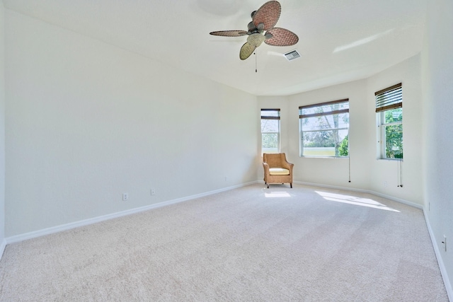 unfurnished room with plenty of natural light, ceiling fan, carpet flooring, and baseboards