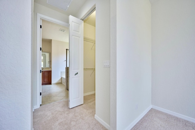 corridor with light colored carpet and baseboards