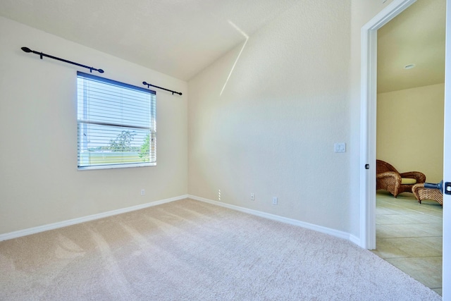unfurnished room with light carpet and baseboards