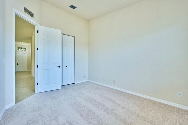 unfurnished bedroom with carpet flooring, baseboards, and a closet