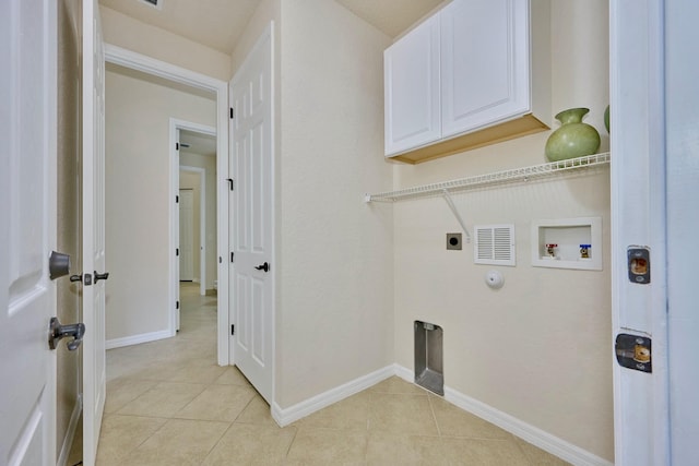 laundry area featuring electric dryer hookup, hookup for a washing machine, light tile patterned floors, cabinet space, and baseboards