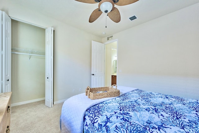 bedroom featuring light colored carpet, baseboards, ceiling fan, and a closet