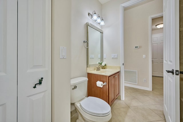 bathroom featuring tile patterned floors, vanity, toilet, and baseboards