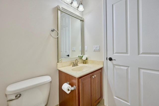 half bathroom with vanity and toilet