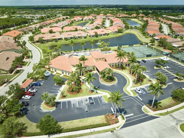 aerial view of property and surrounding area with a nearby body of water and nearby suburban area