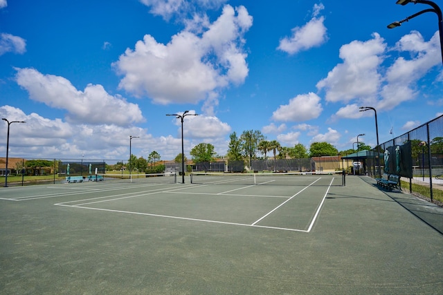 view of tennis court with fence