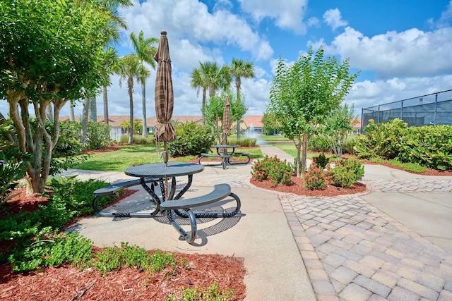 view of home's community with a patio area and fence