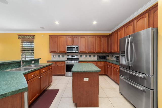 kitchen featuring stainless steel appliances, a center island, a sink, ornamental molding, and dark countertops
