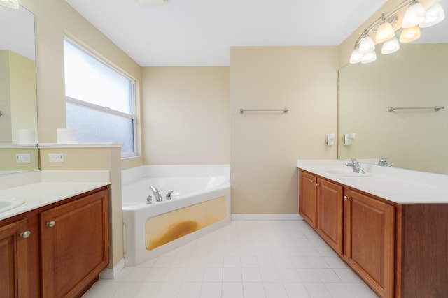 bathroom with a garden tub, two vanities, and baseboards