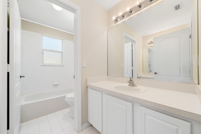 bathroom featuring toilet, tile patterned floors, vanity, baseboards, and shower / tub combination