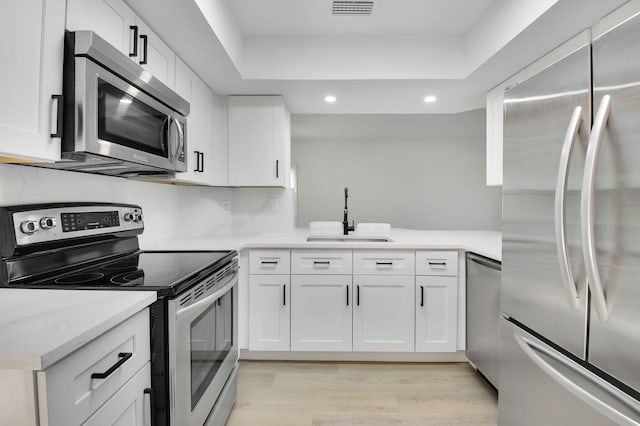 7884 Seville Pl Unit 1301, Boca Raton, FL 33433 - kitchen with appliances with stainless steel finishes, a sink, recessed lighting, light wood finished floors, and white cabinetry