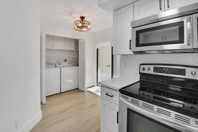 7884 Seville Pl Unit 1301, Boca Raton, FL 33433 - kitchen featuring stainless steel appliances, washing machine and clothes dryer, light wood finished floors, light countertops, and a chandelier