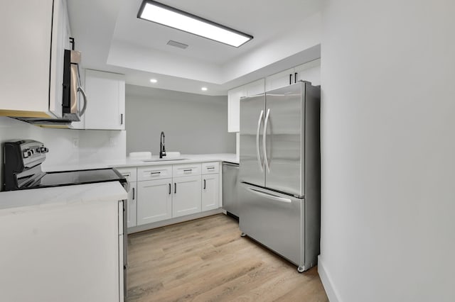 7884 Seville Pl Unit 1301, Boca Raton, FL 33433 - kitchen featuring stainless steel appliances, a sink, recessed lighting, light wood-type flooring, and white cabinets