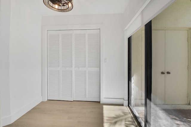 7884 Seville Pl Unit 1301, Boca Raton, FL 33433 - unfurnished bedroom with wood finished floors, multiple closets, and a chandelier