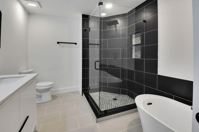 7884 Seville Pl Unit 1301, Boca Raton, FL 33433 - full bathroom with a shower stall, tile patterned floors, a freestanding tub, vanity, and toilet