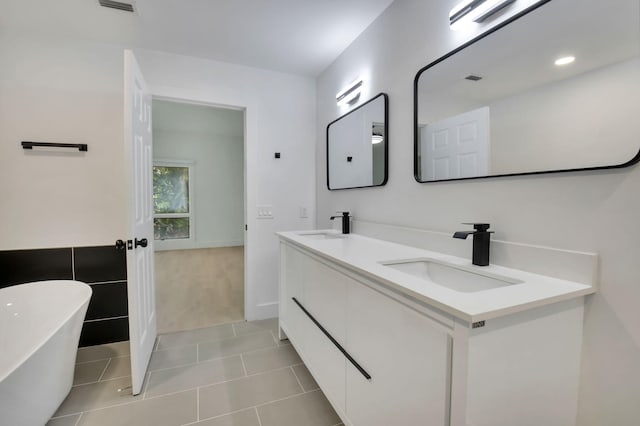 7884 Seville Pl Unit 1301, Boca Raton, FL 33433 - full bath featuring double vanity, a freestanding bath, and tile patterned floors