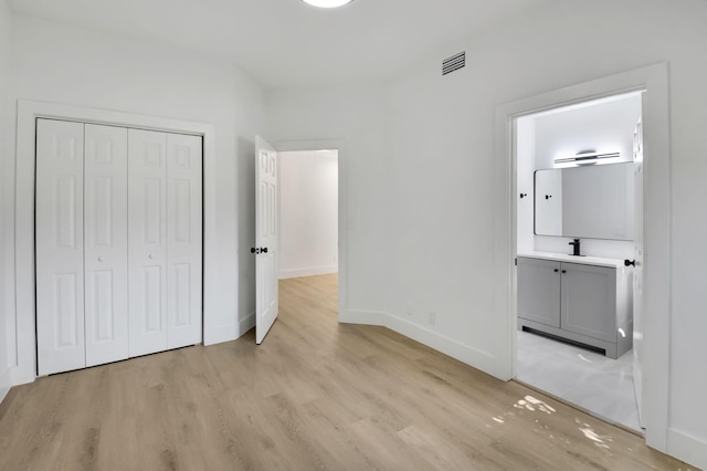 7884 Seville Pl Unit 1301, Boca Raton, FL 33433 - unfurnished bedroom with light wood finished floors, baseboards, a closet, and ensuite bathroom
