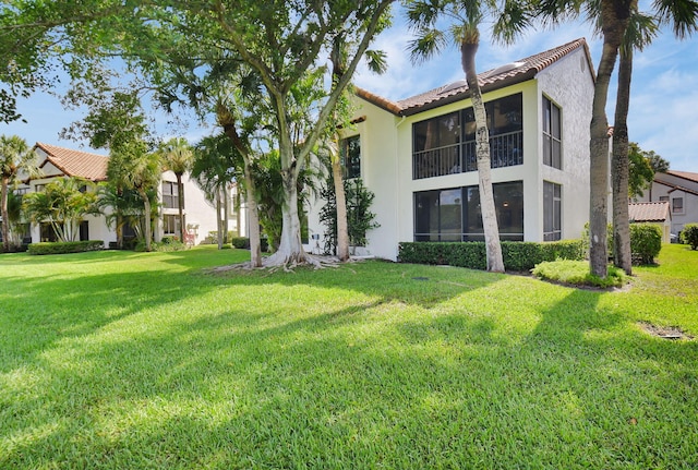 7884 Seville Pl Unit 1301, Boca Raton, FL 33433 - rear view of property with stucco siding, a tile roof, and a yard