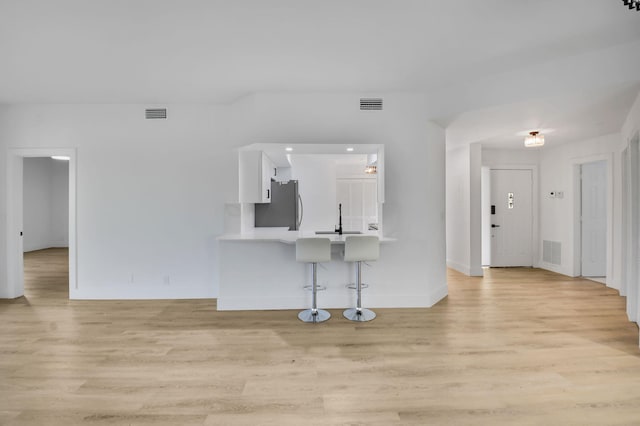 7884 Seville Pl Unit 1301, Boca Raton, FL 33433 - unfurnished living room with light wood finished floors, baseboards, and a sink