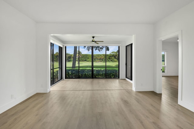 7884 Seville Pl Unit 1301, Boca Raton, FL 33433 - empty room with healthy amount of natural light, wood finished floors, and baseboards