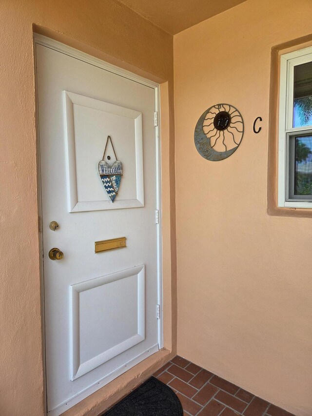 doorway to property with stucco siding