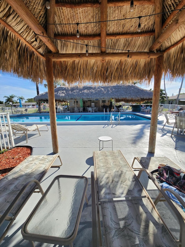 community pool featuring a gazebo and fence