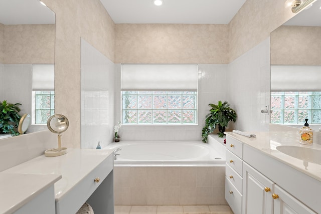 bathroom featuring plenty of natural light, a bath, vanity, and tile patterned floors