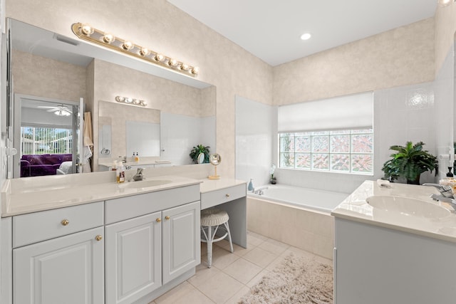 full bathroom featuring tile patterned floors, two vanities, and healthy amount of natural light