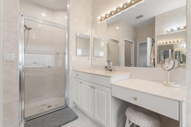 full bath featuring a stall shower, tile patterned flooring, and vanity