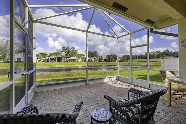 sunroom / solarium with a water view