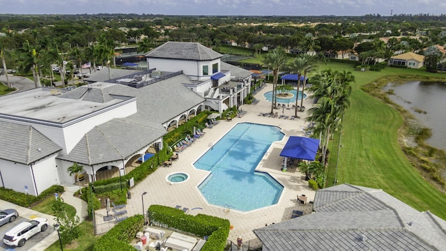 bird's eye view of a pool area and a large body of water