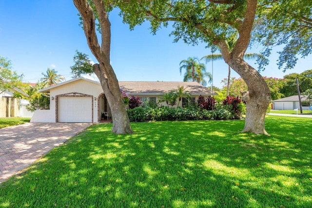 639 Mallard Dr, Delray Beach, FL 33444 - single story home with a garage, decorative driveway, a front lawn, and stucco siding